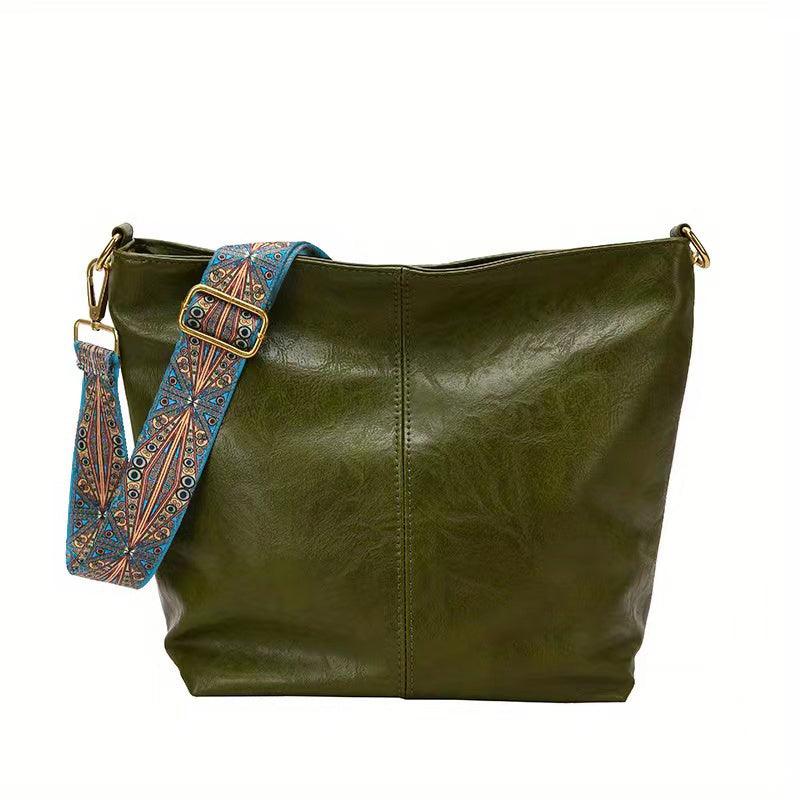 Elegant faux leather women's shoulder bag with a decorative embellished strap, ideal for a sophisticated look.