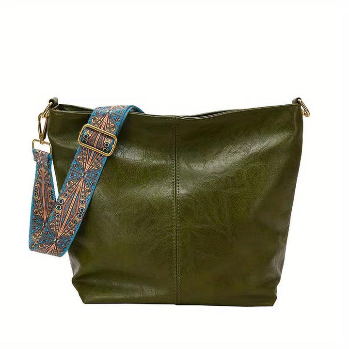 Elegant faux leather women's shoulder bag with a decorative embellished strap, ideal for a sophisticated look.