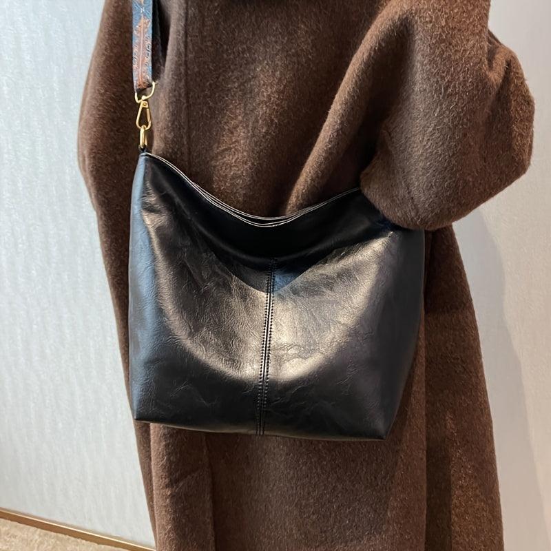 Caramel faux leather shoulder bag for women, featuring a trendy embellished strap. Versatile daily handbag.