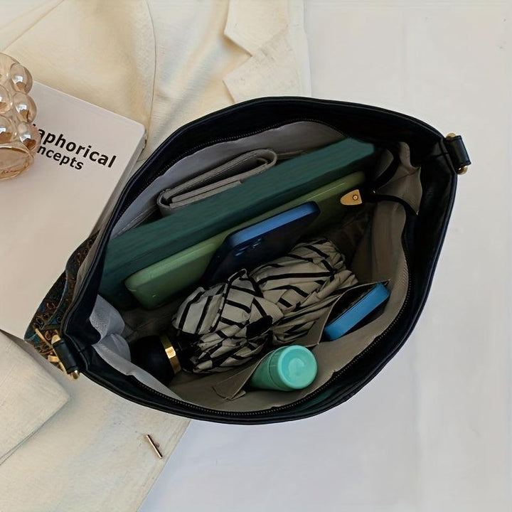 Emerald green faux leather women's shoulder bag with a unique embellished strap. Chic crossbody fashion accessory.