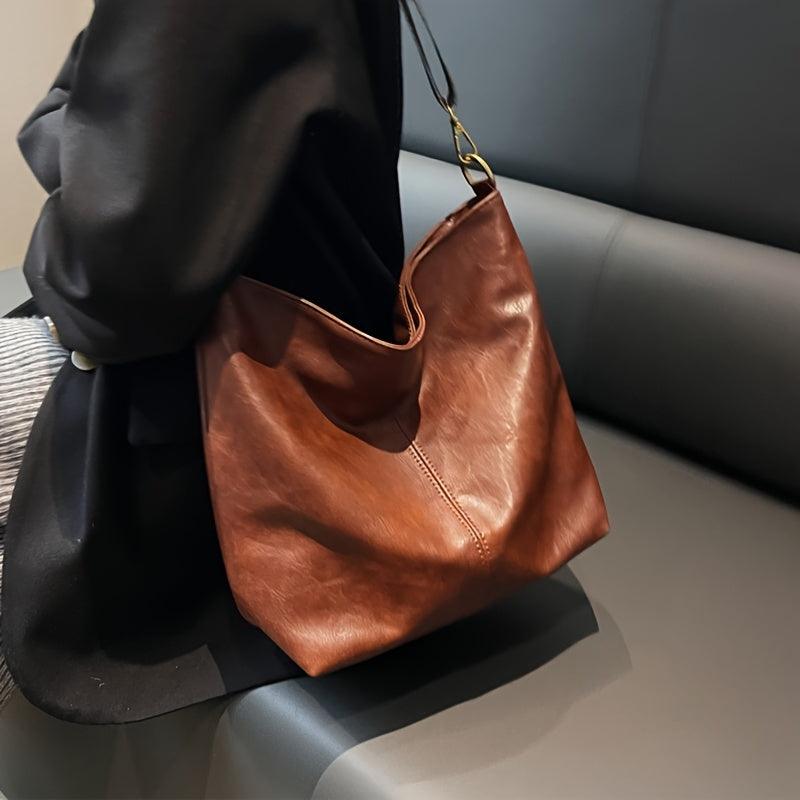 Close-up of the embellished strap on a women's faux leather shoulder bag, highlighting its unique design.