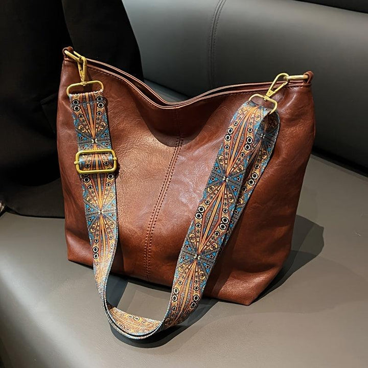 Stylish women's daily bag: chic faux leather shoulder bag with an embellished strap, perfect for any outfit.
