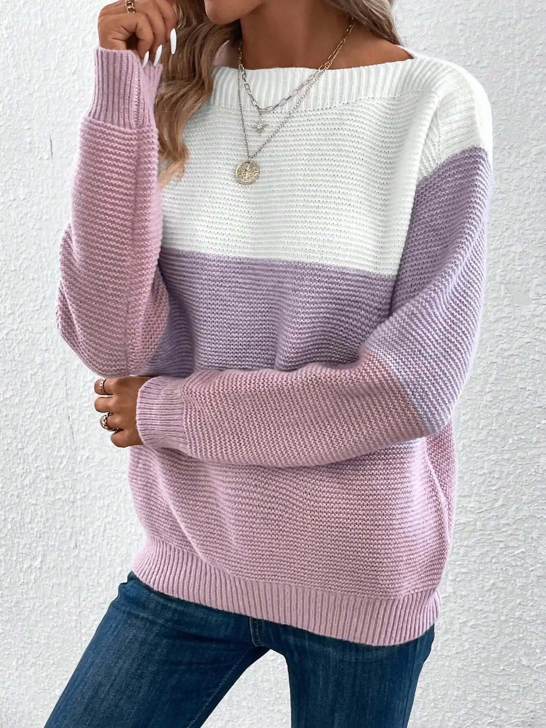 Classic women's long sleeve round neck knit sweater, offering cozy warmth and chic style.