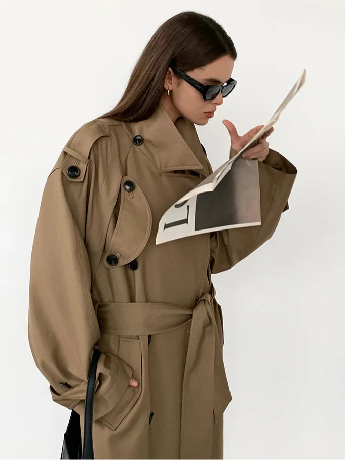 Elegant women's oversized long trench coat with classic double-breasted design.