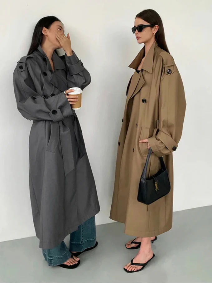 Stylish women's long trench coat, oversized fit for a modern fall fashion look.