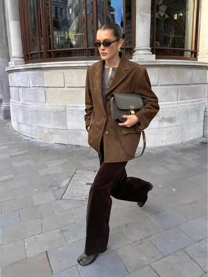 Women's chic button-front oversized suede jacket. Trendy, comfortable, and versatile outerwear for a fashionable look.