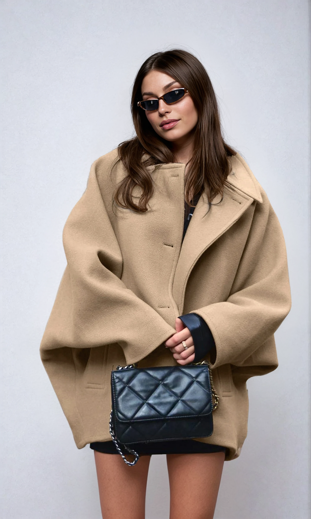 Elegant women's oversized coat, ideal for winter fashion. Stylish outerwear with button closure for cold weather.
