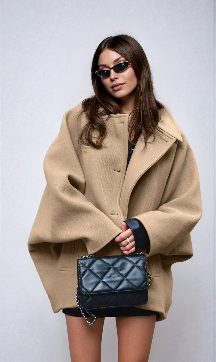 Elegant women's oversized coat, ideal for winter fashion. Stylish outerwear with button closure for cold weather.