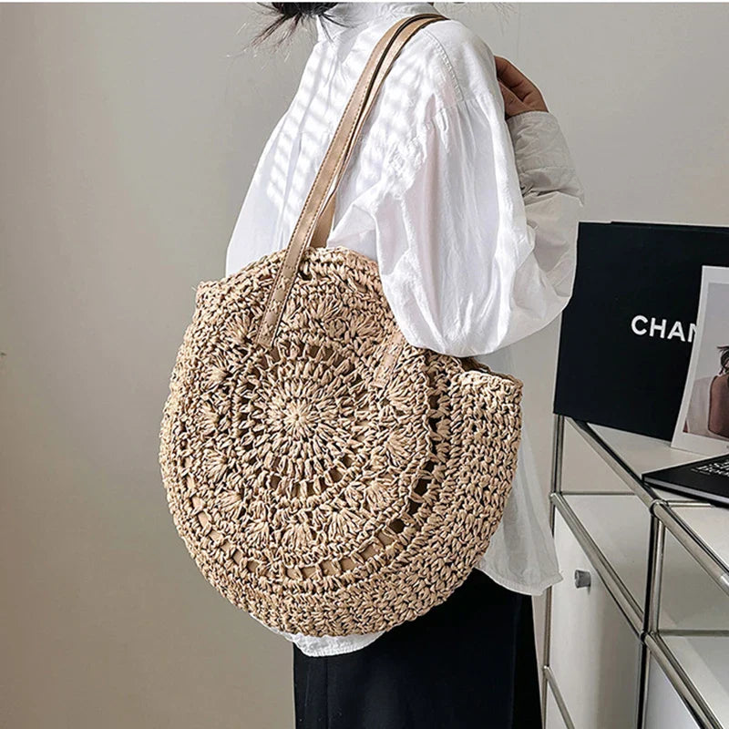 Chic women's round woven beach tote bag. Natural straw style, perfect for summer vacations & boho looks.