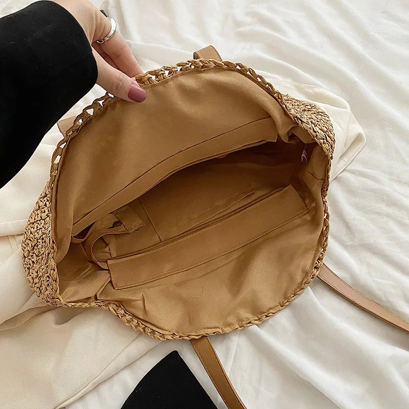Elegant round woven straw beach bag. Natural style women's tote, perfect for summer, vacation, and seaside.