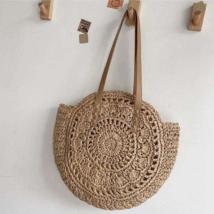 Stylish women's round woven boho beach tote. Natural straw shoulder bag, great for summer vacation.