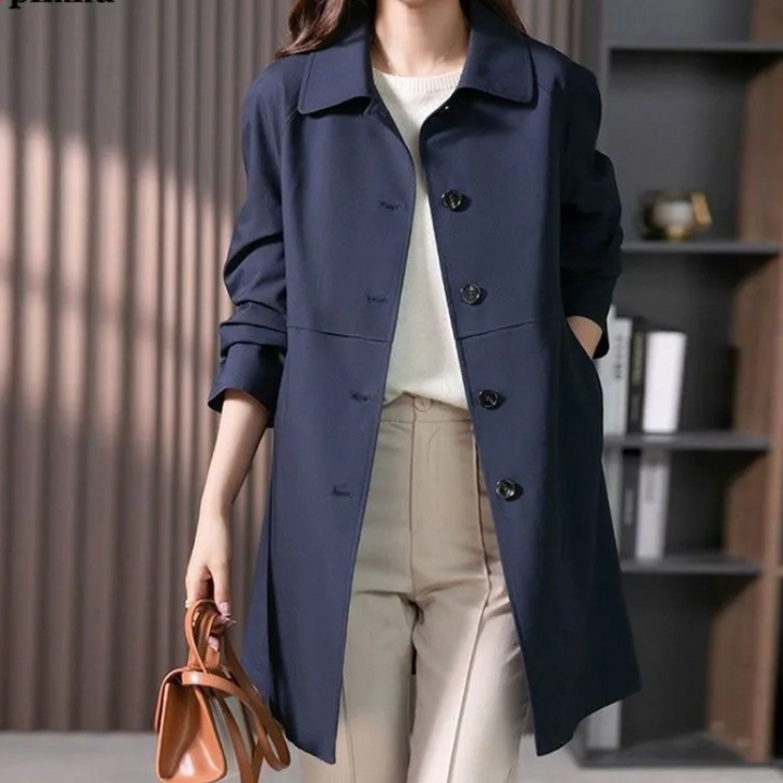 Elegant women's short trench coat with single button closure. A classic stylish jacket for fall fashion.