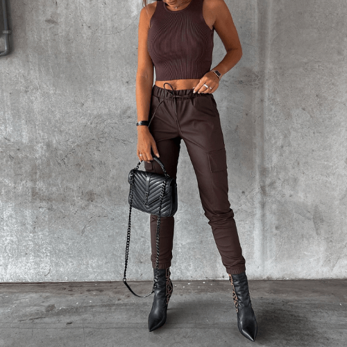 Women's sleek black slim fit cargo pants in PU leather, offering a modern & comfortable style.