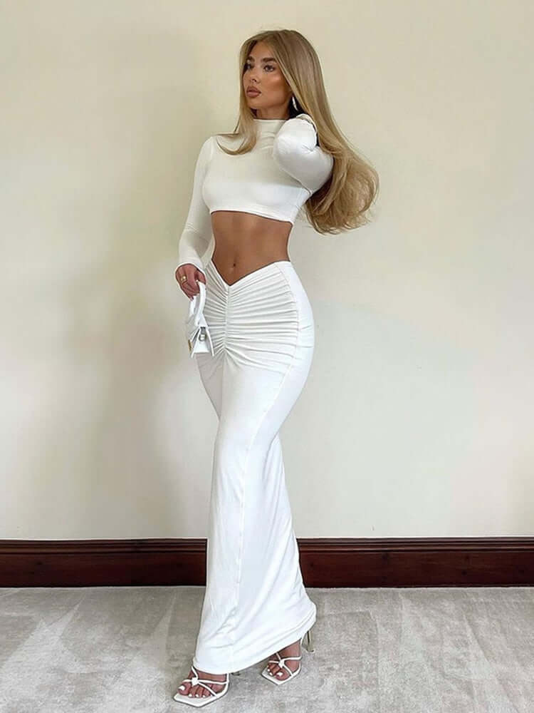 Elegant women's bodycon long sleeve crop top & high-waisted ruched maxi skirt set. Perfect for parties.