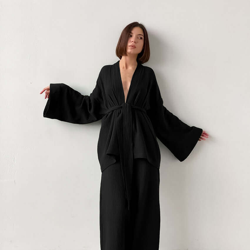 Stylish women's v-neck top & wide-leg trousers set. Effortless spring/summer fashion, perfect elegant casual outfit.