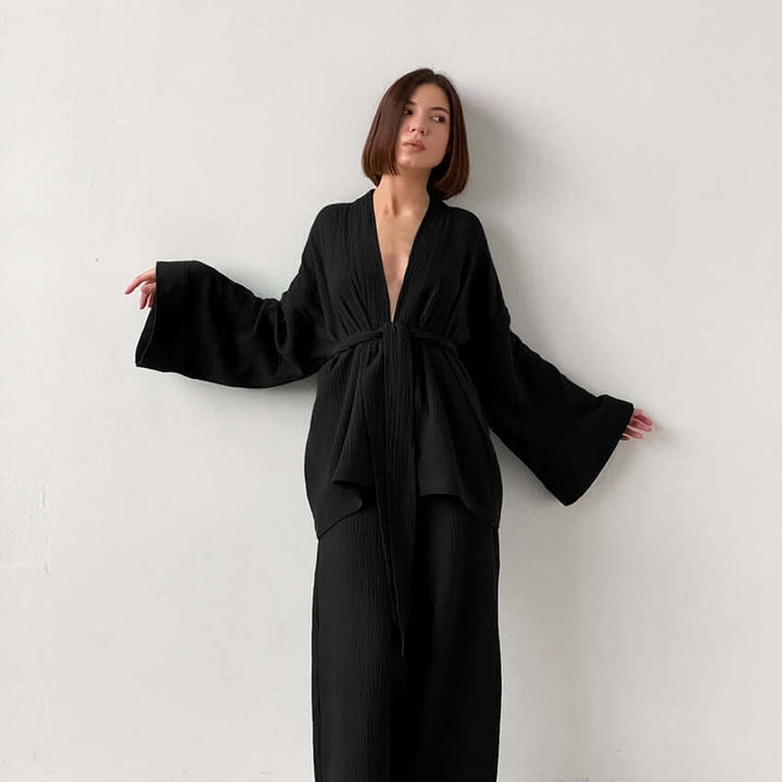 Stylish women's v-neck top & wide-leg trousers set. Effortless spring/summer fashion, perfect elegant casual outfit.