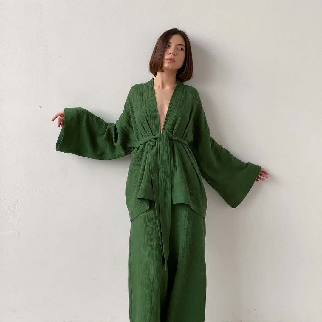 Women's chic two-piece V-neck top & wide-leg trousers set. Comfortable, elegant, and versatile for modern style.