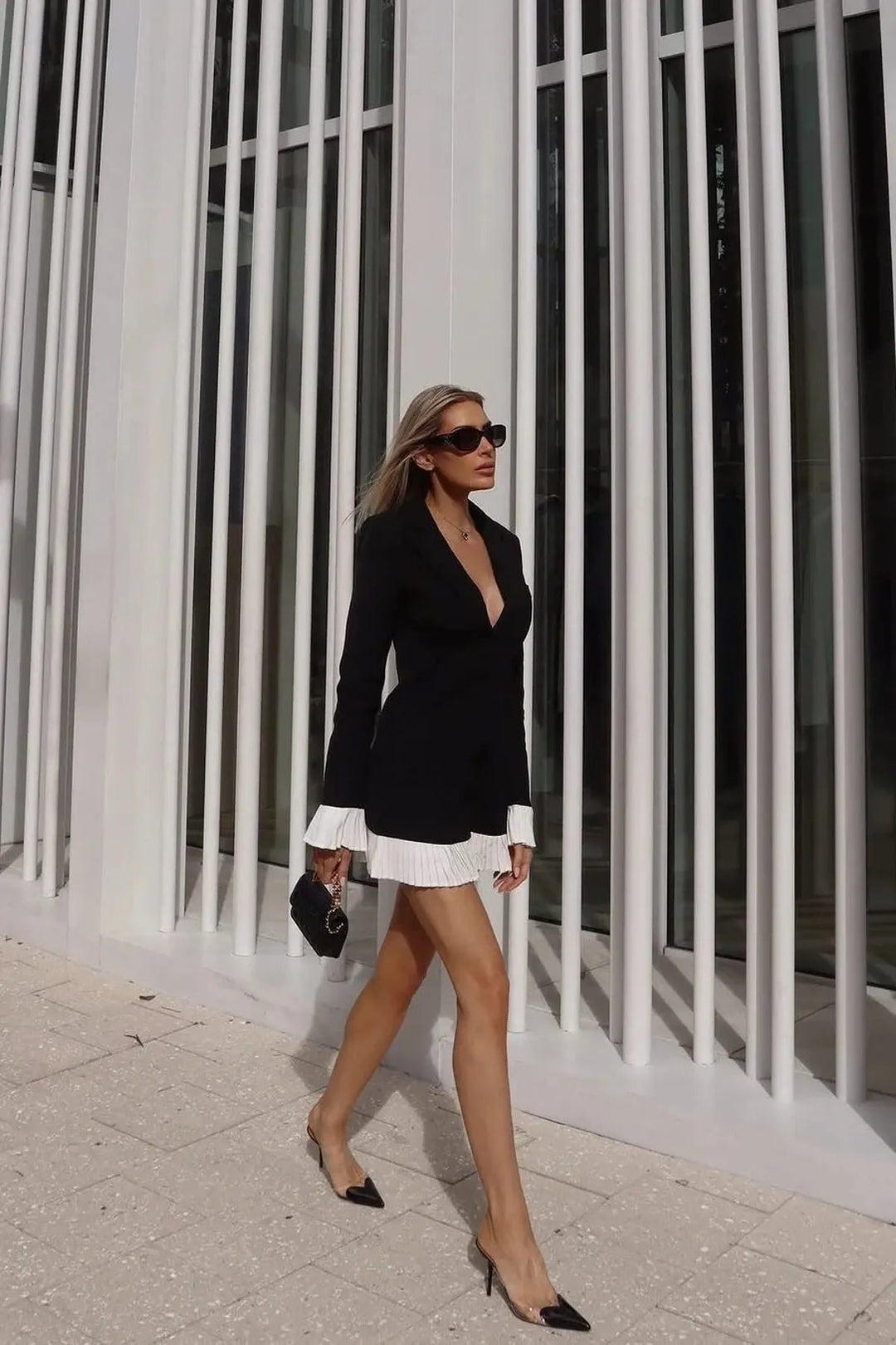 Elegant women's pleated mini dress, V-neck, button front. Sophisticated chic style for cocktail or day events.