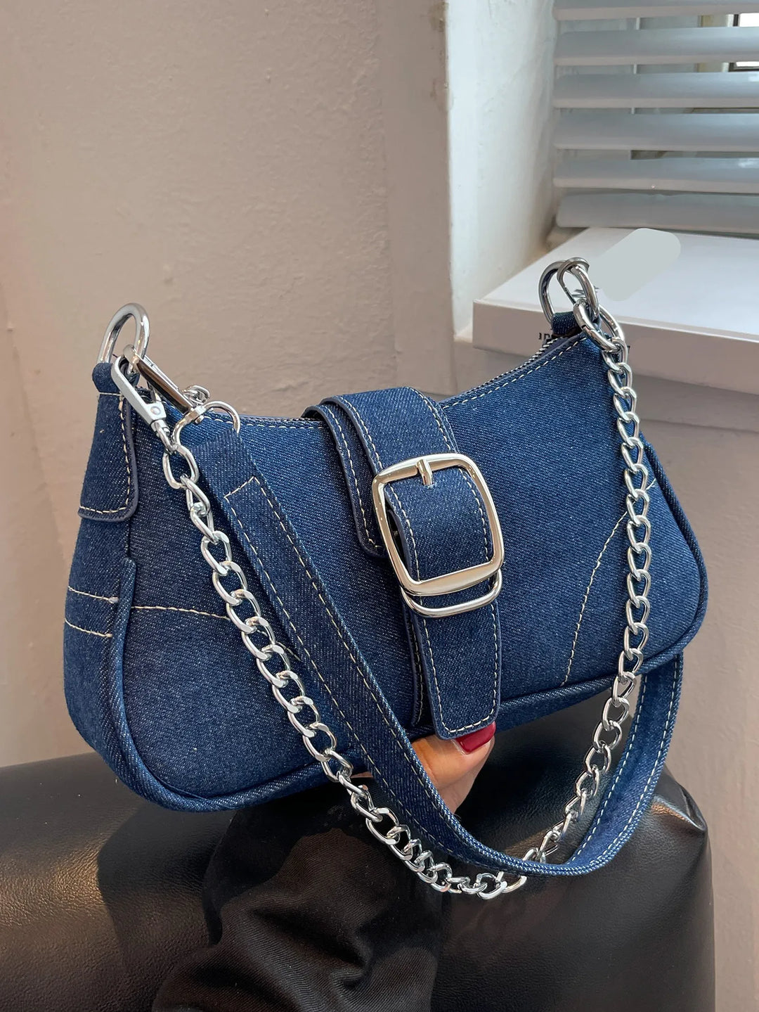 Classic dark blue women's buckle two-way shoulder handbag, versatile for everyday use.