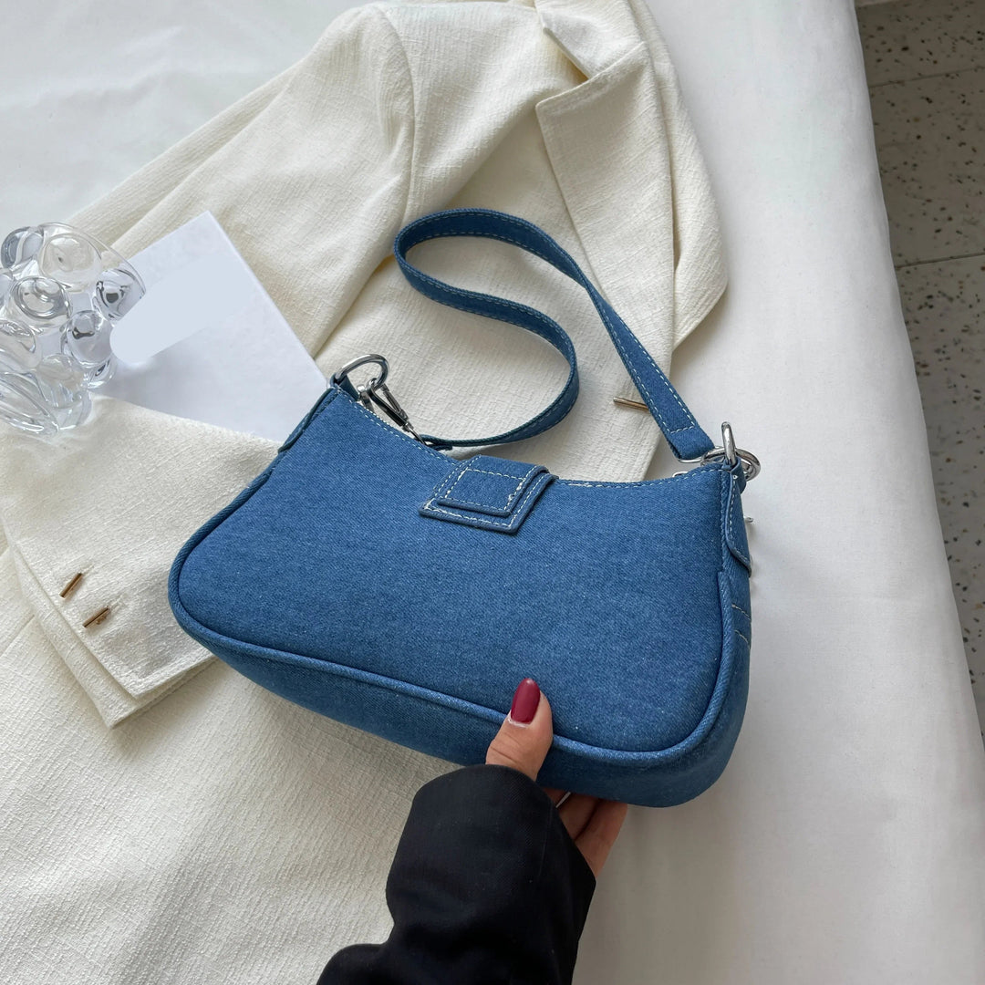 Stylish dark blue women's handbag with elegant buckle, convertible from shoulder bag to everyday carry.