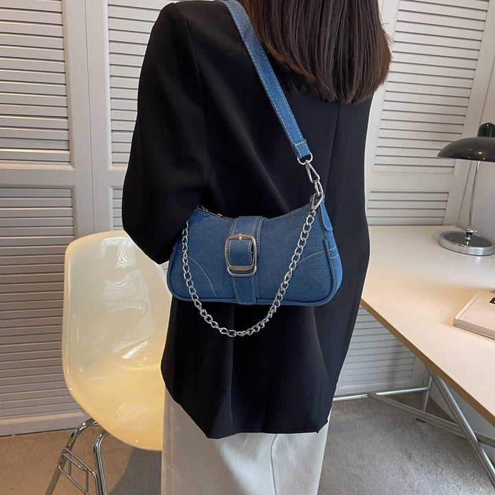 Elegant dark blue women's buckle shoulder bag, a fashionable two-way handbag for modern women.