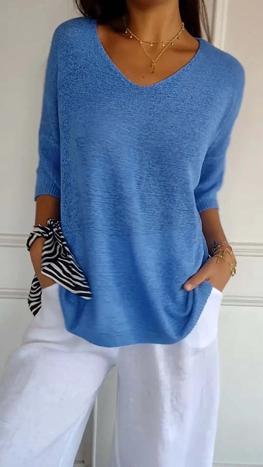 Stylish women's long sleeve V-neck knit top, perfect for casual everyday comfort and versatile fashion.