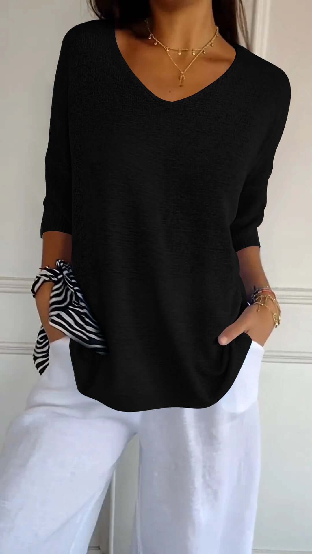 Detail of the soft fabric of a women's long sleeve V-neck knit top, emphasizing comfort and quality.