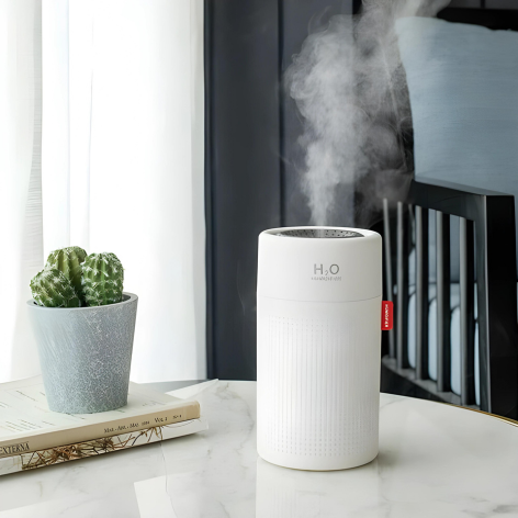 Compact blue and white portable rechargeable humidifier, enhancing air moisture, perfect for travel and home use.