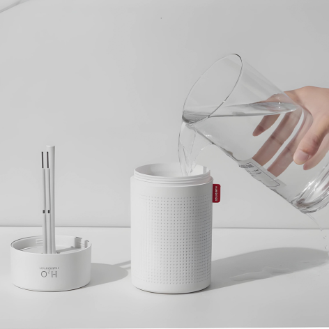 Compact blue and white portable rechargeable humidifier, enhancing air moisture, perfect for travel and home use.