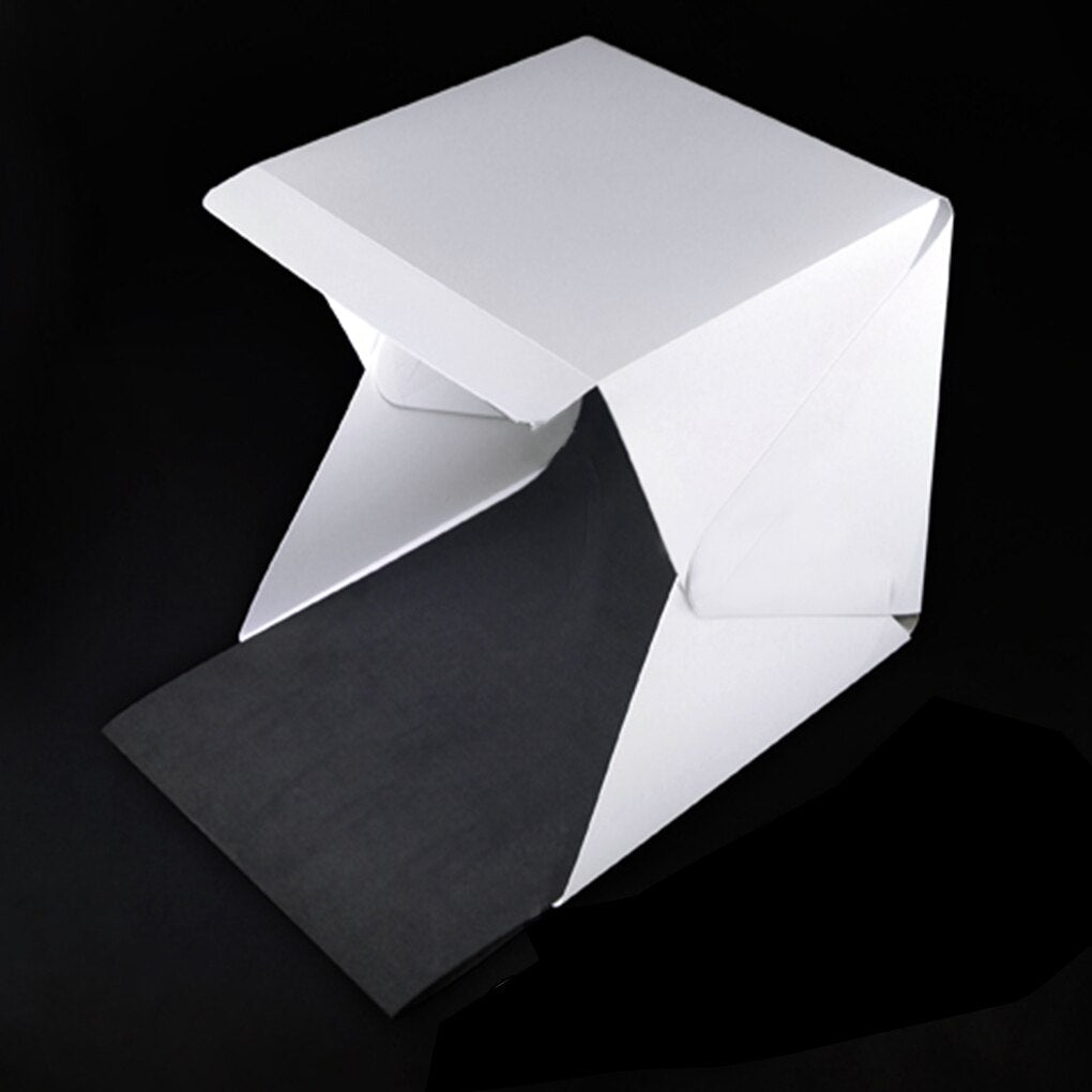 Portable photography light box studio for crisp product shots, includes multiple backgrounds.