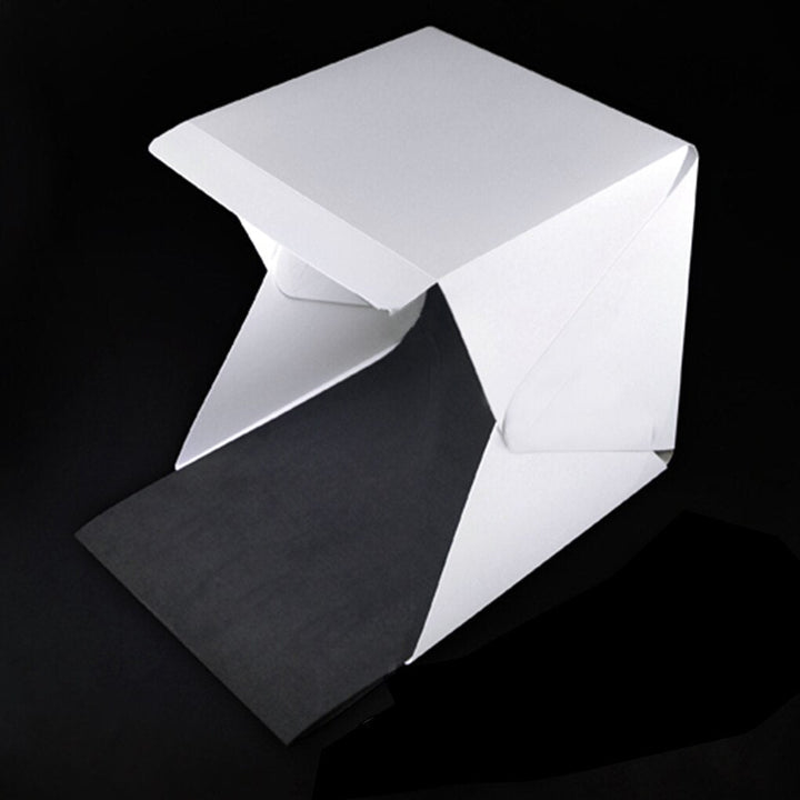 Portable photography light box studio for crisp product shots, includes multiple backgrounds.
