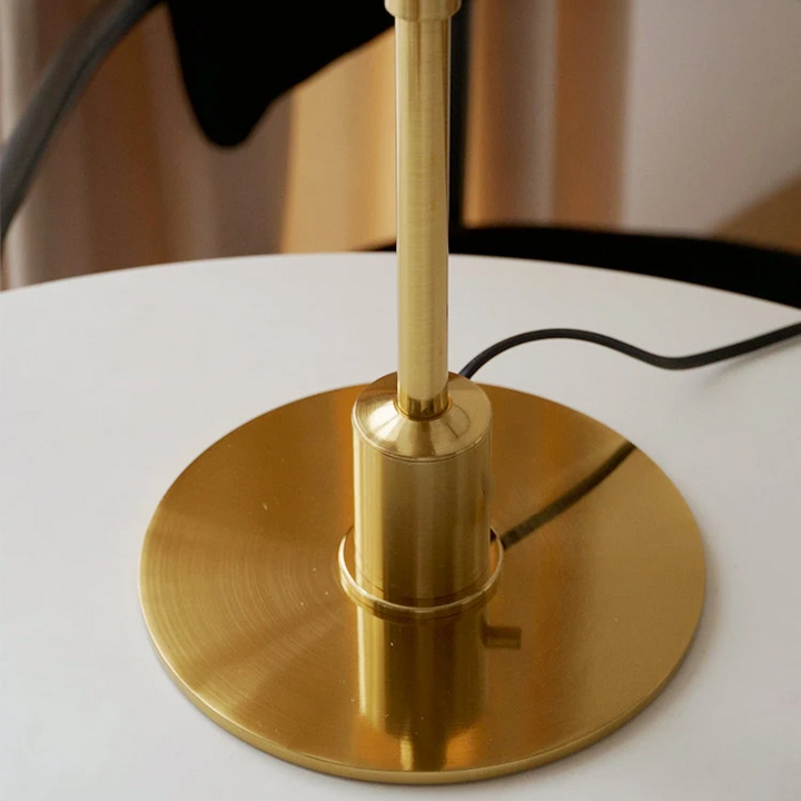 Contemporary Danish designer table lamp with warm LED light, sleek Scandinavian form, amber finish, and premium glass.