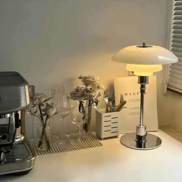 Contemporary Danish designer table lamp with warm LED light, sleek Scandinavian form, amber finish, and premium glass.