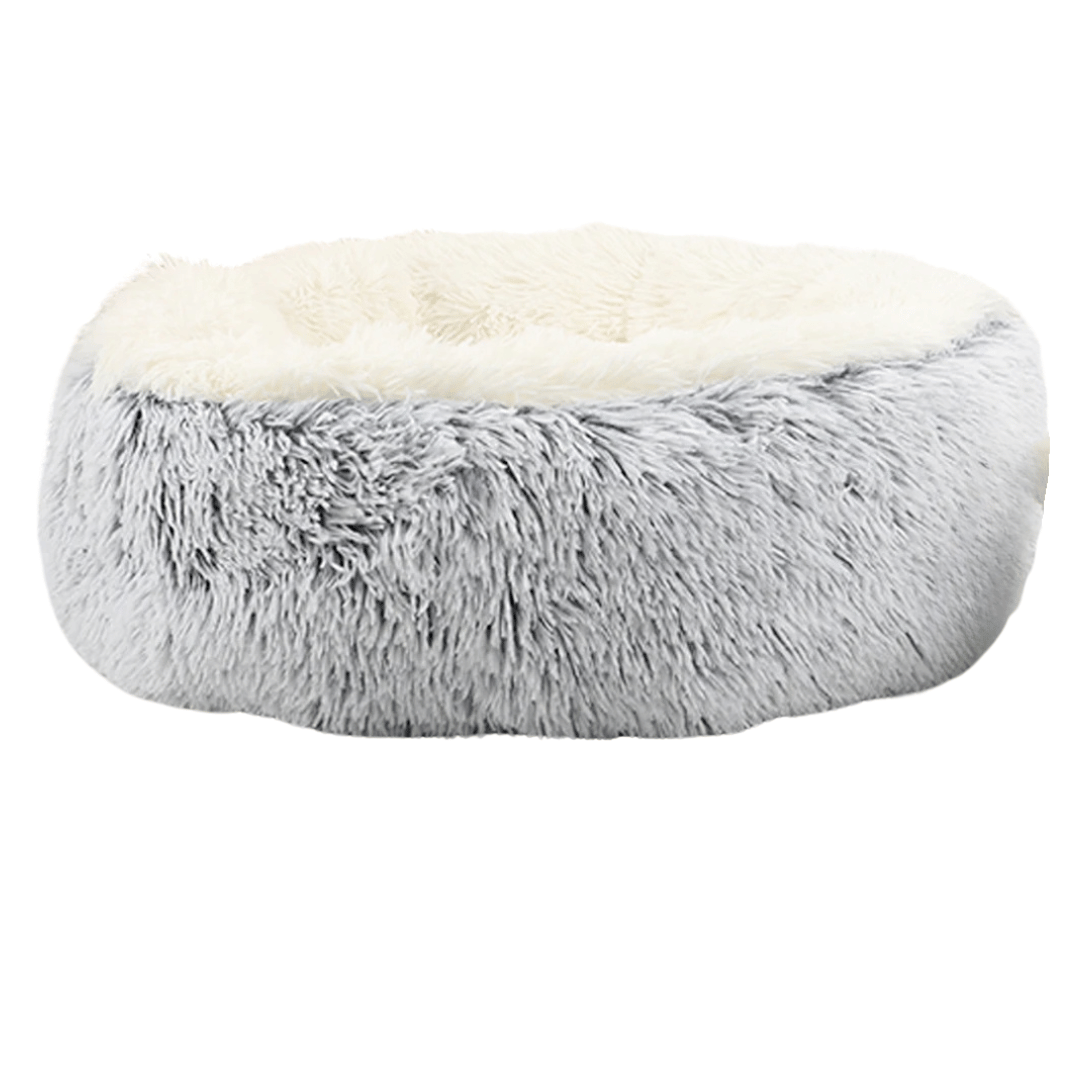 "Cozy plush donut dog bed with deep sides, faux fur, circular shape for comfort and anxiety relief in various sizes."