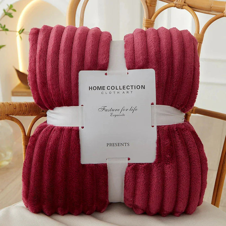 Inviting wide-stripe plush fleece throw blanket for cozy moments, adding warmth and softness to your space.
