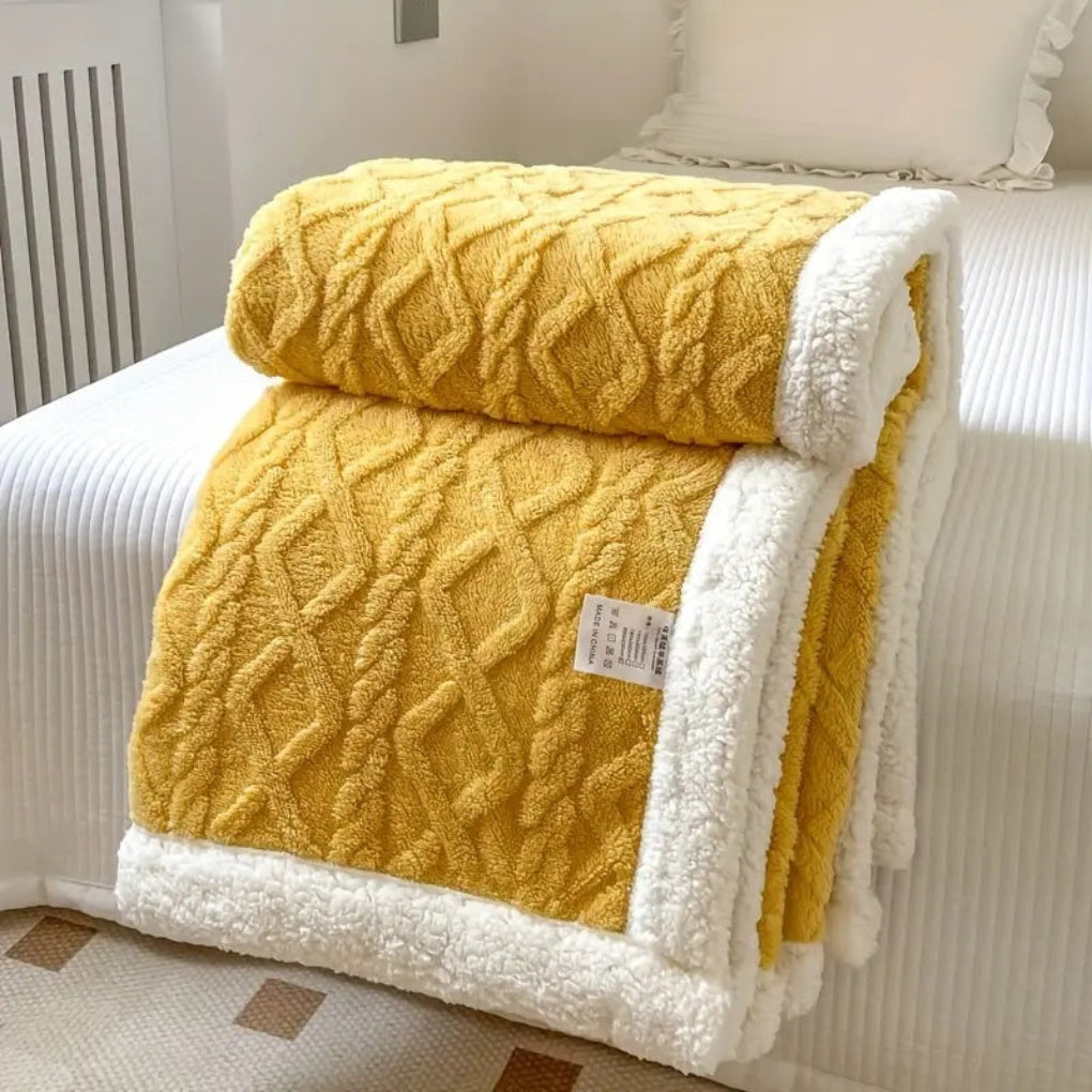 Soft fleece and sherpa blanket with unique diamond knit pattern, providing warmth and comfort as a bed throw.