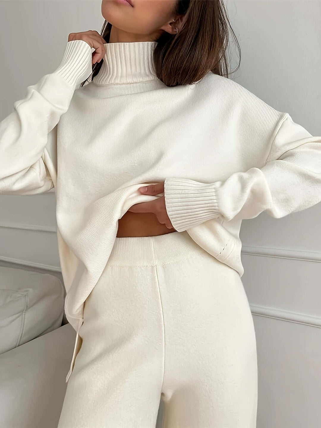 Cozy white knitted turtleneck sweater & matching knit pants set for women, perfect lounge wear & autumn fashion.