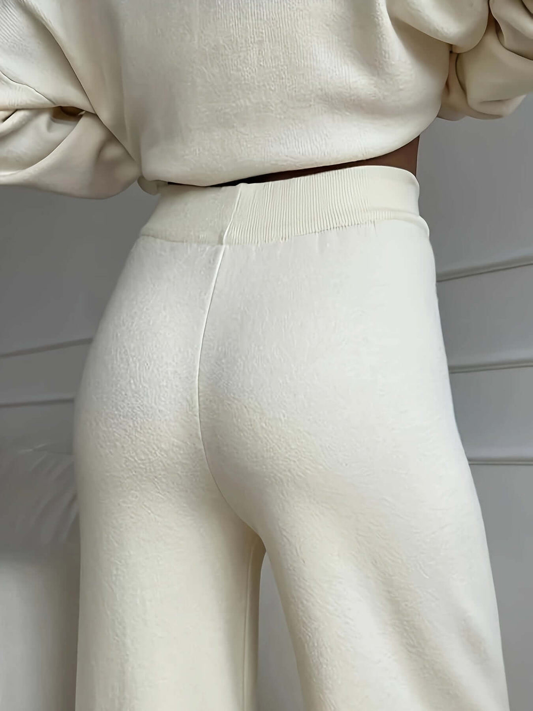 Women's cozy white knitted turtleneck sweater & soft knit pants set, ultimate comfortable lounge wear outfit.
