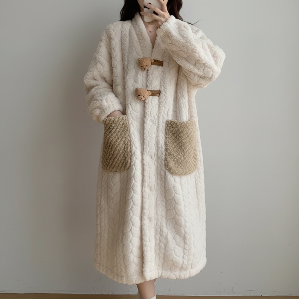 Woman relaxing in a comfortable hooded long sleeve robe, ideal cozy winter sleepwear & home wear.