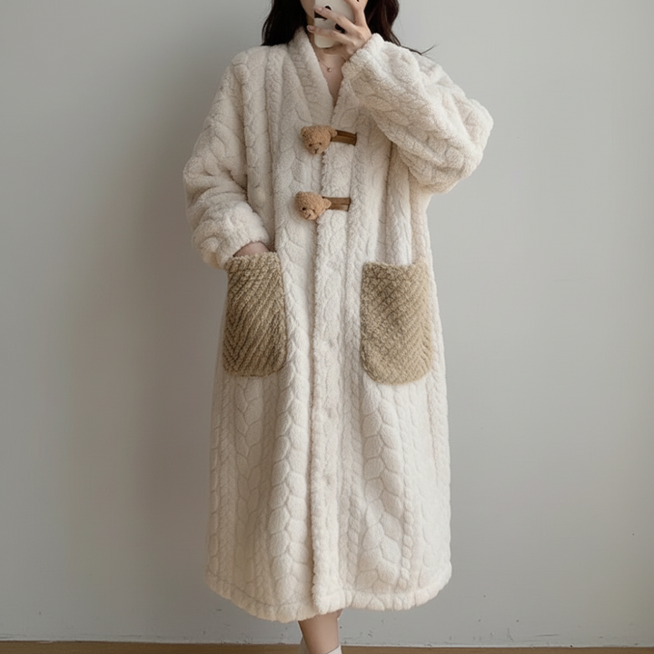Woman relaxing in a comfortable hooded long sleeve robe, ideal cozy winter sleepwear & home wear.