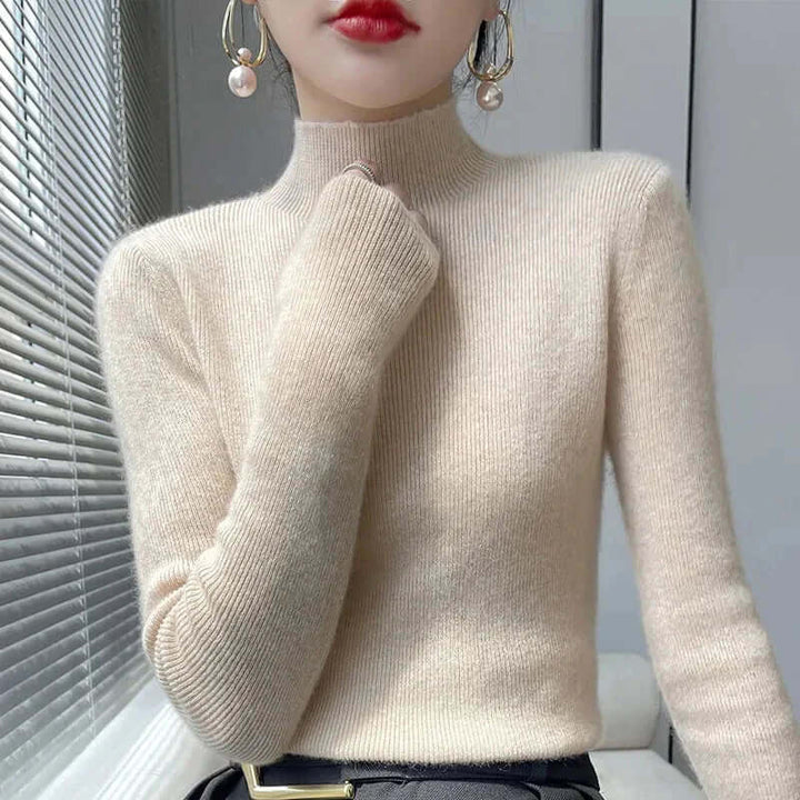 Warm acrylic blend knitted sweater for women, featuring a cozy half turtleneck & ribbed cuffs.