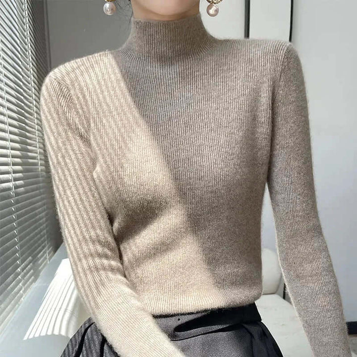 Knitted long sleeve women's sweater with a flattering half turtleneck, cozy for cold days.