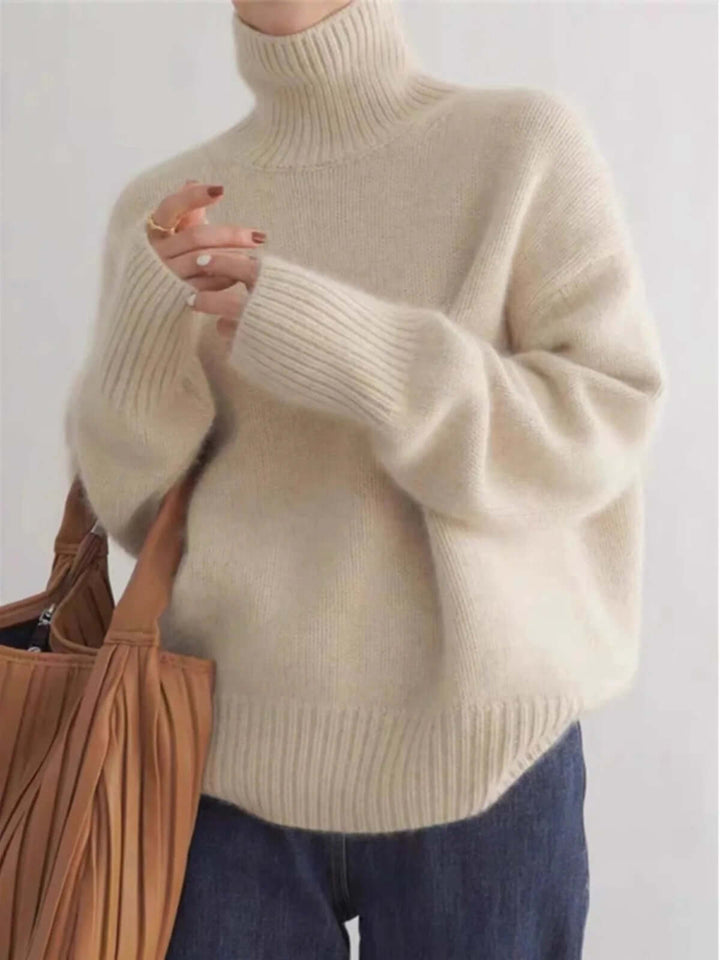 Stylish women's loose fit knit sweater with high neck, ideal for effortless layering in fall/winter fashion.