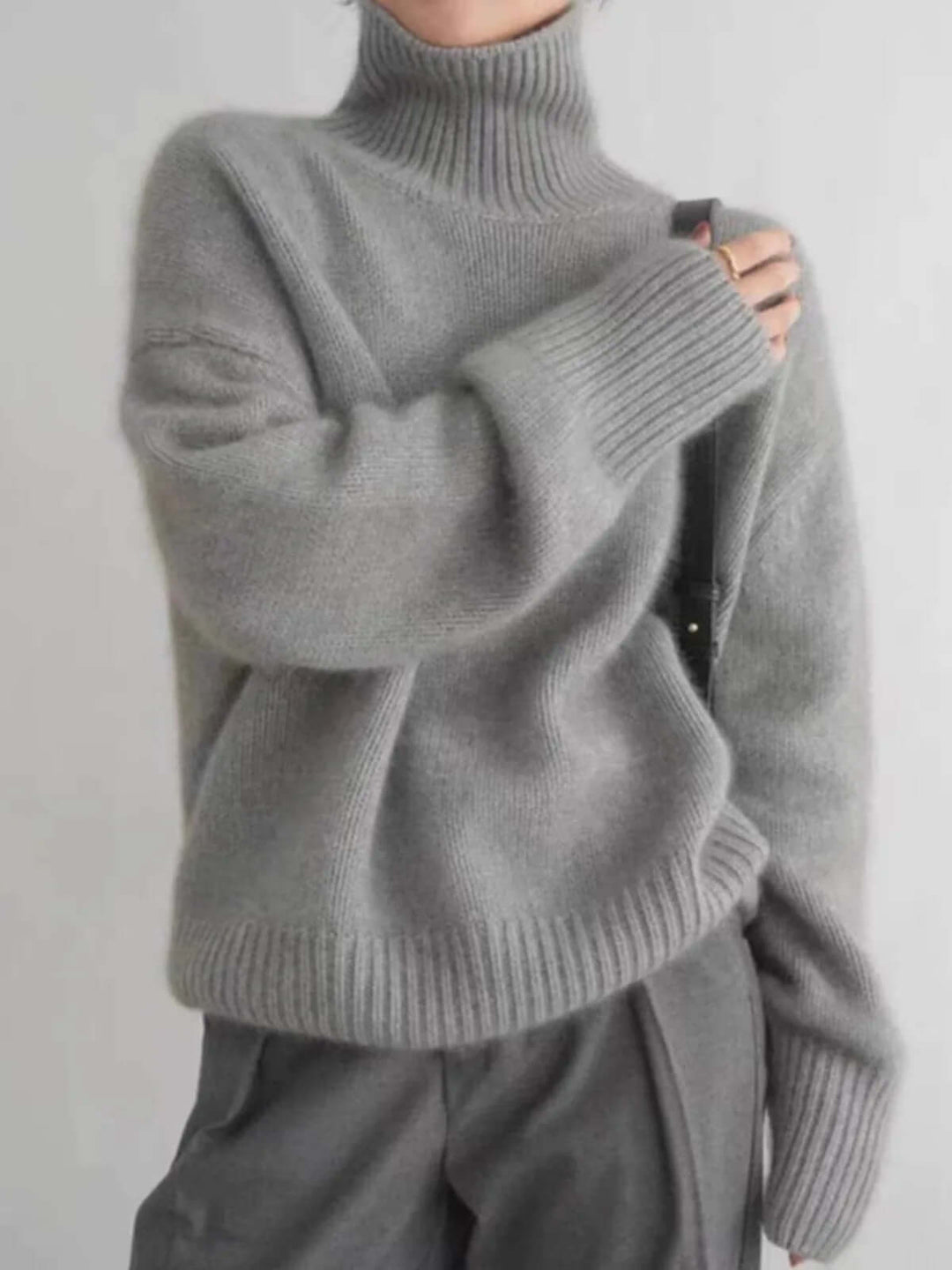Relaxed women's acrylic blend loose knit high neck sweater, offering ultimate cozy comfort for cool weather.