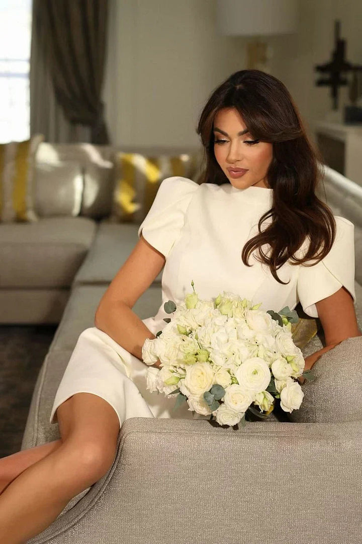 White women's puff sleeve mini dress, a chic and cute cocktail party outfit.