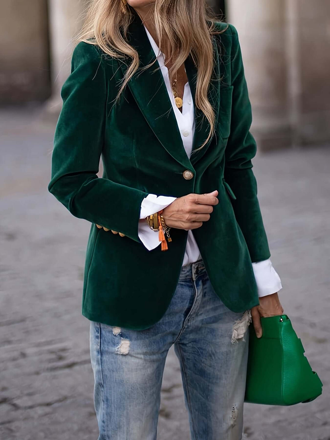 Chic women's dark green velvet blazer, professional and elegant with stylish golden buttons.