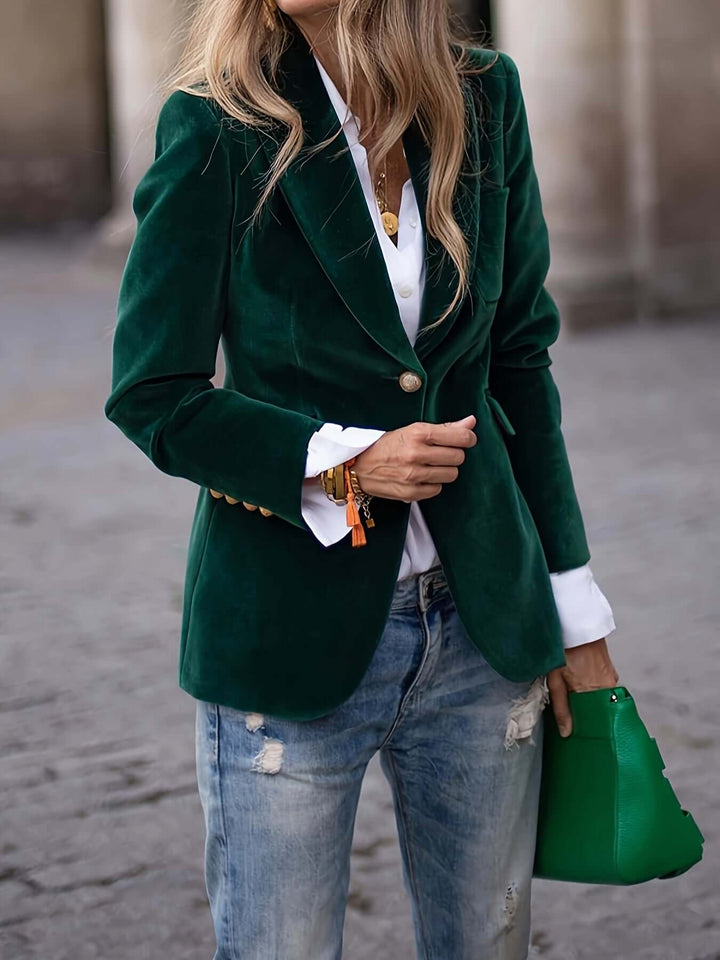 Chic women's dark green velvet blazer, professional and elegant with stylish golden buttons.