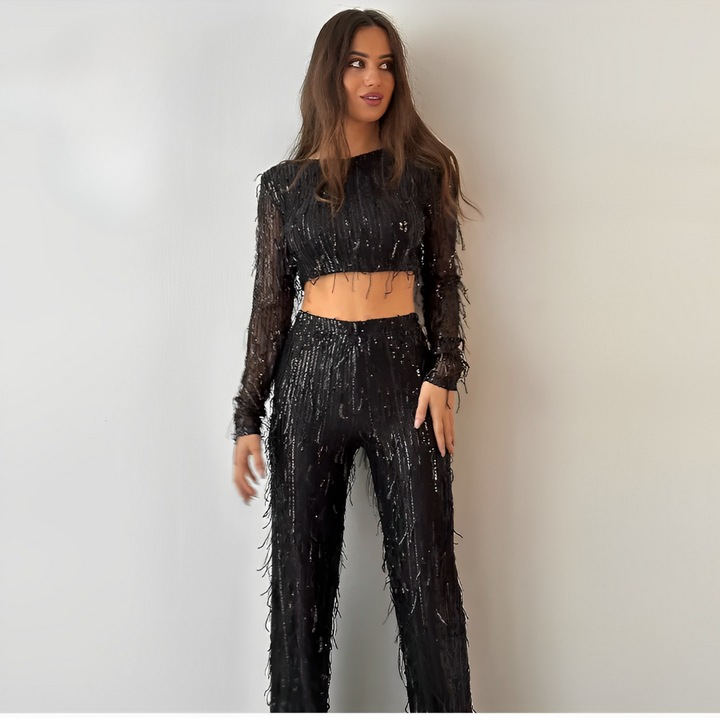 Stylish women's sequin two-piece set with a fringe crop top & high-waisted skirt. Perfect for dazzling club wear.