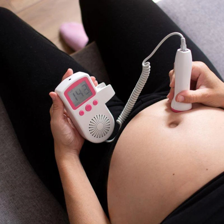 "Doppler heart rate monitor, handheld device for mothers to track baby's heartbeat, compact design, user-friendly controls."