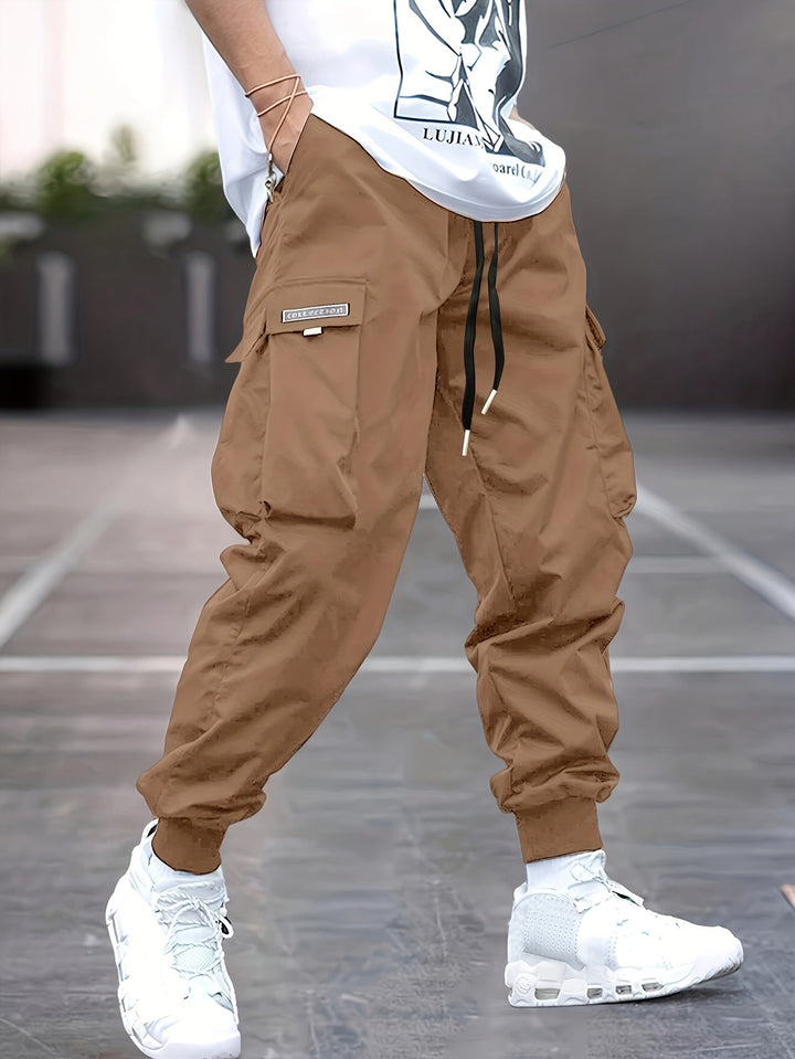 "Durable men's black cargo pants front view with multiple pockets, sleek modern fit, versatile style for urban adventures."